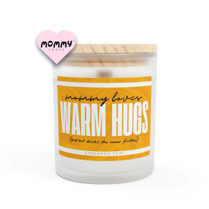The perfect gift for mom, especially for mother's day. A frosted glass scented candle, with a wooden lid. The glass vessel is 11 oz, and the wax is 9oz. Burning time is around 50 hours. The label is beautifully designed in light brown, creamy colors, and it says: Mommy Loves Warm Hugs. Underneath, in between brackets it says: and hot drinks she never finishes. A funny, yet original gift for mom! The scent is cinnamon chai. Super relaxing.