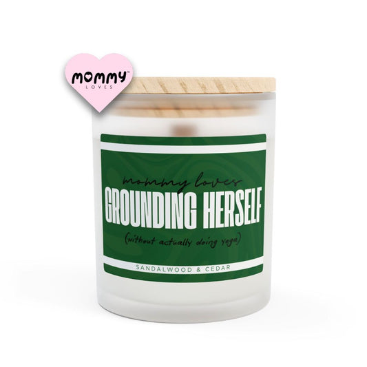 The perfect gift for mom, especially for mother's day. A frosted glass scented candle, with a wooden lid. The glass vessel is 11 oz, and the wax is 9oz. Burning time is around 50 hours. The label is beautifully designed in dark green colors, and it says: Mommy Loves Grounding Herself. Underneath, in between brackets it says: without actually doing yoga. A funny, yet original gift for mom! The fragrance is sandalwood & cedar. Super relaxing.