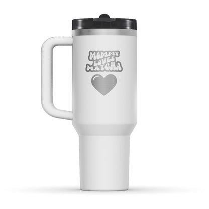The back side of the newest Stanley 40oz Tumbler. The perfect gift for mother’s day. The Color of the cup is Chalk, which is similar to white. It’s engraved with a typically 70s retro-style font, saying Mommy Loves Matcha. Under that text there is a nice big heart in the same retro style.