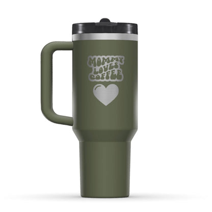Stanley 40oz Tumbler, with a personalized twist. The perfect gift for mom. The Color of the cup is Dried Pine, a shade of army green. It’s engraved with a typically 70s retro-style font, saying Mommy Loves Coffee. Under that text there is a nice big heart in the same style. 