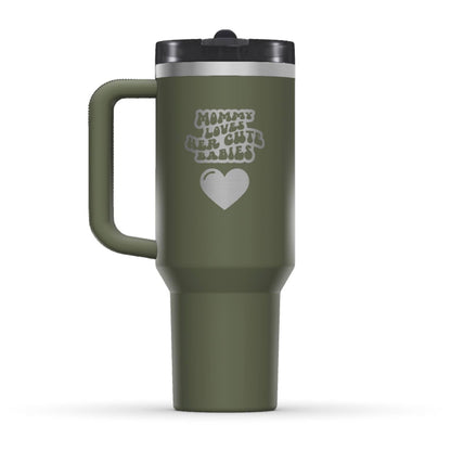 The back side of the newest Stanley 40oz Tumbler. The perfect gift for mother's day. The Color of the cup is Dried Pine, similar to dark army green. It’s engraved with a typically 70s retro-style font, saying Mommy Loves Her Cute Babies. Under that text there is a nice big heart in the same retro style.