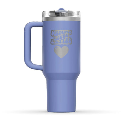 The back side of the newest Stanley 40oz Tumbler. The perfect gift for mom. The Color of the cup is Hydrangea, a shade of cyan blue. It’s engraved with a typically 70s retro-style font, saying Mommy Loves Lattes. Under that text there is a nice big heart in the same retro style.